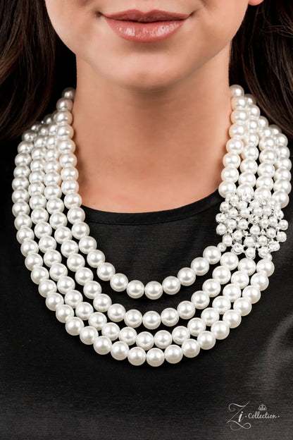 Inspired by royalty, an elegant explosion of classic white rhinestones and timeless pearls delicately coalesces into a vintage brooch. The refined ornament delicately holds together strands of oversized pearls, creating romantically regal layers below the collar. Features an adjustable clasp closure.