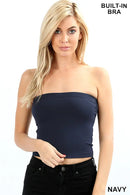 Woman wearing a navy tube top with built-in bra paired with black pants